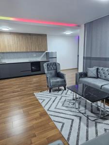 a living room with a couch and chairs and a piano at Dino Saraj in Skopje
