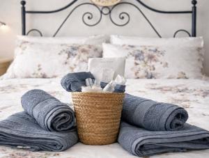 a bedroom with towels and a basket on a bed at Little Medieval House Nettuno in Nettuno