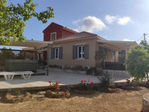 a house with a bench in front of it at Spedion Kefallonia - Villas with jaccuzzi in Pesádha