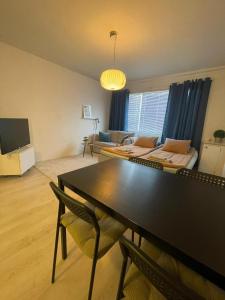a living room with a table and a couch at Apartment with a wonderful location! in Lappeenranta