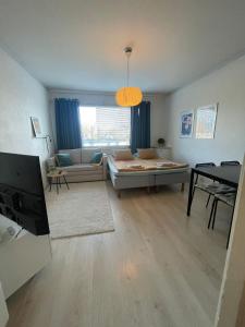 a living room with a couch and a table at Apartment with a wonderful location! in Lappeenranta