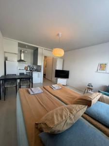 a bedroom with two beds and a dining room at Apartment with a wonderful location! in Lappeenranta