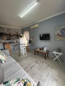 a living room with a couch and a table at Cottage 49 in Parys
