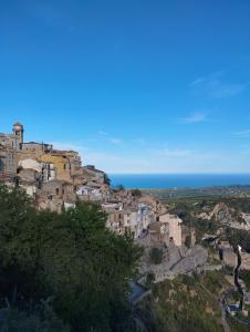 a group of buildings on a hill with the ocean at Casa Adamo 77 in Badolato
