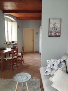 a living room with a couch and a table at Casa Adamo 77 in Badolato