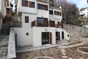 a white building with balconies on the side of it at Villa Elea in Milies Pelion in Mileai