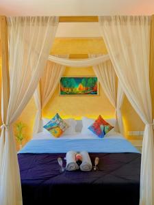 a bedroom with a bed with two pairs of slippers at 1BHK Suite with Balcony and Pool View in Noida