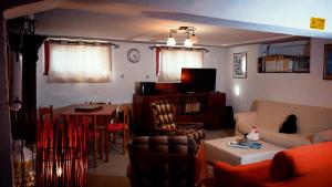 a living room with a couch and a table at Camera Alcova in giardino in Cellino Attanasio