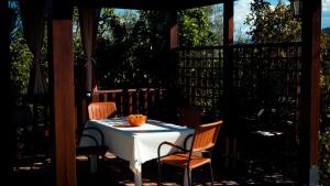 a table and two chairs on a patio with a table and chairs at Camera Alcova in giardino in Cellino Attanasio