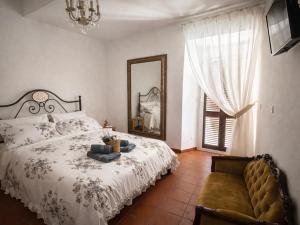 a bedroom with a bed with a mirror and a chair at Little Medieval House Nettuno in Nettuno
