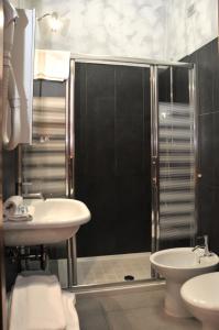 a bathroom with a shower and a sink and a toilet at Hotel Venezia in Caorle
