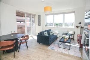 a living room with a couch and a table at Little Haven Thames view Free Parking Closer to Heathrow in Staines