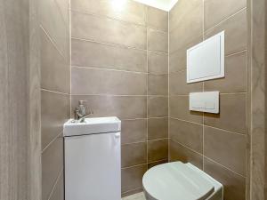 a bathroom with a toilet and a sink at Apartmán/byt Liptovský Mikuláš in Liptovský Mikuláš +5 photos