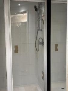 a bathroom with a shower with a glass door at The Flat in Tintinhull