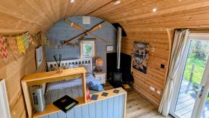 a small room with a bed in a wooden house at Emlyn's Coppice - Luxury Woodland Glamping in Holywell +62 photos