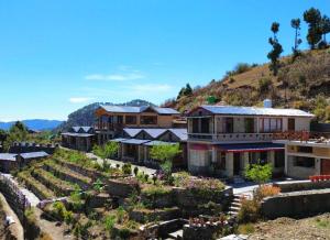 an aerial view of a house with a garden at Meraki Huts in Pauri