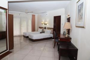 a hotel room with two beds and a piano at Ctrl Alt Heal Sparsh Integrated Wellness Center in Hyderabad