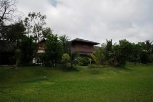a house in a yard with a green lawn at Ctrl Alt Heal Sparsh Integrated Wellness Center in Hyderabad
