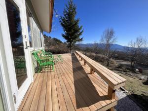 a wooden deck with two benches on a house at Guesthouse HOALOHA 4 SEASONS in Chino +163 photos