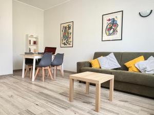 a living room with a couch and a table at Sabo Urban Stay in Grassobbio