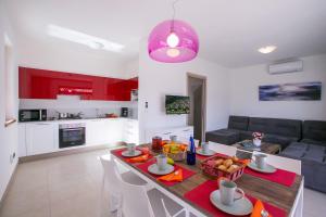 a kitchen and living room with a table with food on it at Villa Inti in Tremezzo