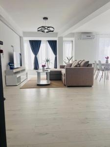 a living room with a couch and a table at Apartamente CASA MIRIAM in Lugoj