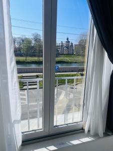 a window with a view of a building at Apartamente CASA MIRIAM in Lugoj