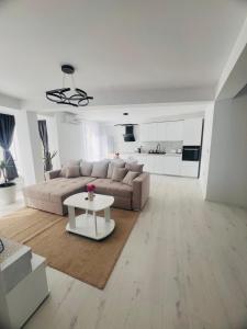 a living room with a couch and a table at Apartamente CASA MIRIAM in Lugoj