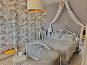 a bedroom with a white bed and a chair at LA MONGEARDIERE in Ay