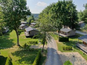 an aerial view of a village with houses and trees at Moulin de Hotton in Hotton