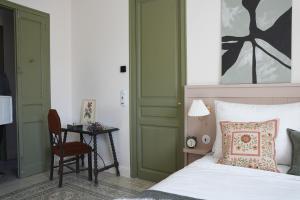 a bedroom with a bed and a chair and a table at La Torre Retreat in Borredá