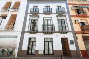 a white building with windows and a door at Alameda 1851 - Private jacuzzi in Seville