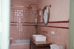 a bathroom with a sink and a mirror and a tub at La Torre Retreat in Borredá