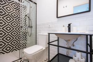 a bathroom with a toilet and a sink and a shower at Alameda 1851 - Private jacuzzi in Seville +15 photos