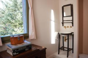 a room with a table with books and a mirror at La Torre Retreat in Borredá +52 photos