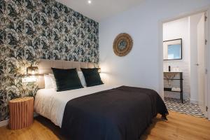 a bedroom with a large bed with a wall mural at Alameda 1851 - Private jacuzzi in Seville