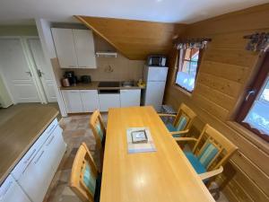 a kitchen with a wooden table and chairs in a caravan at Apartmán U Šáfy, Krkonoše in Svoboda nad Úpou