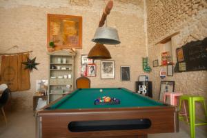 a room with a pool table and a bell at La Norélie in Saint-Sulpice-de-Royan