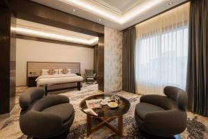 a hotel room with a bed and chairs and a table at Ananta Express, Katra in Katra +33 photos
