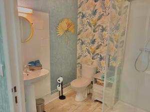 a bathroom with a toilet and a sink at LA MONGEARDIERE in Ay