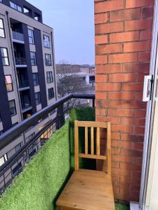 a wooden bench sitting on the balcony of a building at One bedroom Flat in Birmingham City Centre with free underground parking in Birmingham