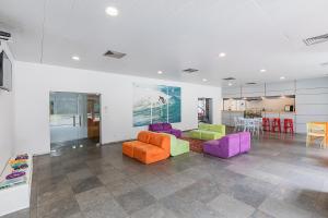 a living room with colorful chairs and a table at Hi Espinho - Pousada de Juventude in Espinho