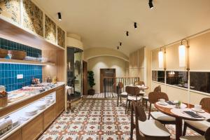 a dining room with a table and chairs at H10 Raco del Pi Boutique hotel in Barcelona