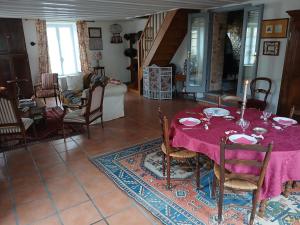 a dining room with a table with a pink table cloth at Chambres d'hôtes de la Barbinière in Chantonnay +17 photos