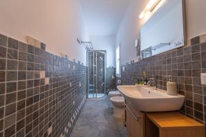 a bathroom with a sink and a toilet and a mirror at Les Suites Magnolia in Olbia +94 photos