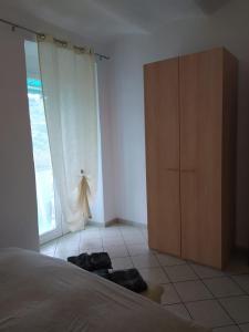 a bedroom with a bed and a dresser and a window at Isabella in Vallebona +1 photo