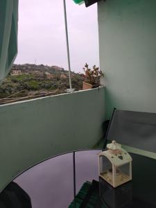 a room with a table with a view of a city at Isabella in Vallebona