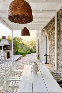 a patio with a white table and a stone wall at Salt & Stone in Drymon