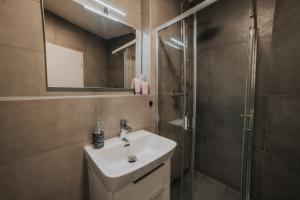 a bathroom with a sink and a shower at Apartmán Melissa in Žilina