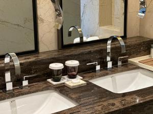 a bathroom counter with two sinks and two faucets at Hotel Nikko Xiamen in Xiamen +10 photos